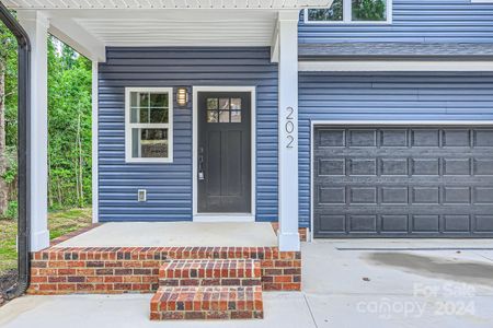 Beautiful modern front porch and parking area.