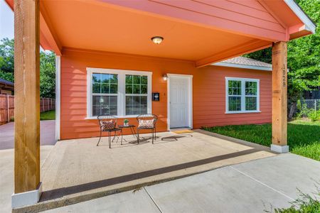 View of exterior entry with a patio