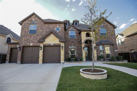 View of front of home featuring a front yard and a garage