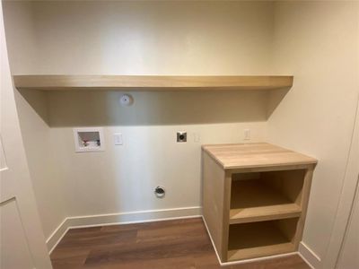 Laundry room featuring washer hookup, dark hardwood / wood-style floors, and electric dryer hookup