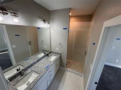 Bathroom featuring vanity and an enclosed shower