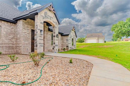 View of home's exterior featuring a garage and a yard