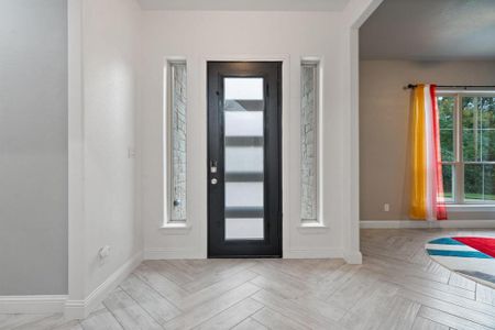 Foyer entrance with light parquet flooring