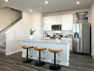 The Cool design package has grey granite countertops, taupe EVP Flooring, and beige tweed carpet.