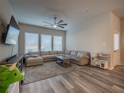 the family room is open to the kitchen and dining area-large windows for natural light