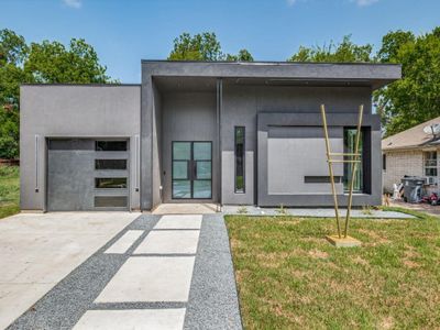 Contemporary house with a garage and a front yard