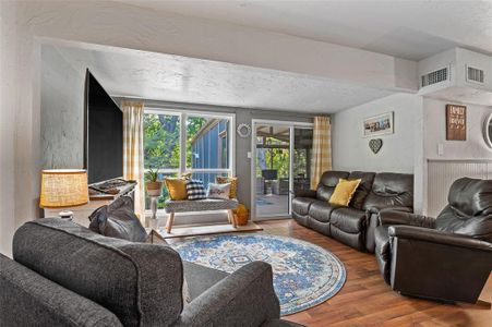 Living room with wood-style floors and flooded with natural light and a beautiful view