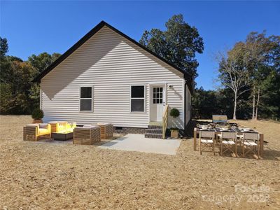 Great outdoor living with concrete Patio in large back yard.