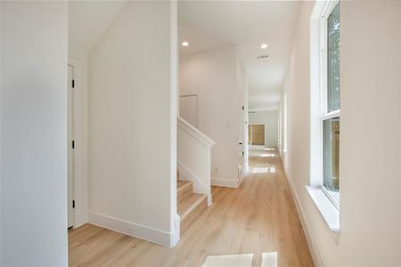 Hallway with light hardwood / wood-style flooring