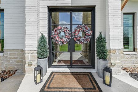 Inviting grand entryway with elegant double doors.