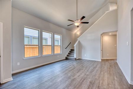 As you step across the threshold, you'll enter the spacious and inviting family room, greeted by a soaring vaulted ceiling and large double-paned windows that fill the space with abundant natural light.