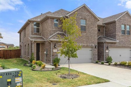 Front of property with a garage and a front lawn