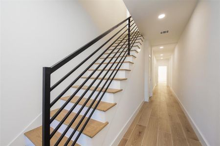 Staircase featuring hardwood / wood-style floors