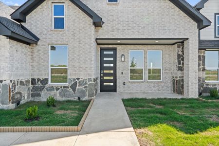 View of exterior entry with a yard