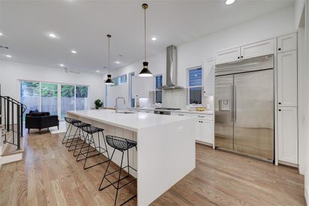 A statement kitchen with full walk in pantry, refrigerator and beverage cooler. (Photos reflective of similar unit. Alternate refrigerator in unit.)