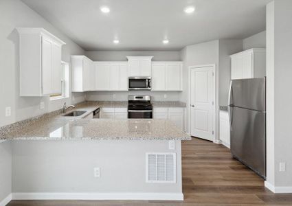 The kitchen of the Yale floor plan includes beautiful white cabinets.