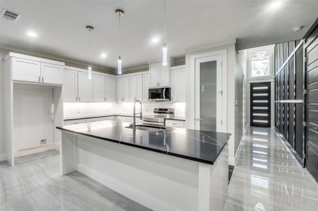 Beautiful Kitchen with real wood cabinetry, upgraded counter tops, pendant lights and Mahogany 8ft entry door and interior doors with a frosted pantry door!