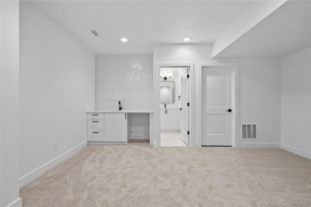 Basement living space with wet bar and full bathroom