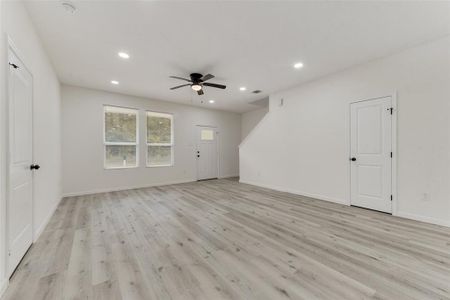 Empty room featuring ceiling fan and light hardwood / wood-style flooring