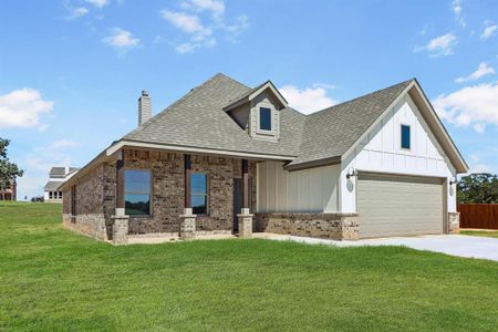 View of front of home featuring a garage and a front lawn