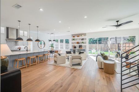 Living room featuring ceiling fan and light hardwood / wood-style floors