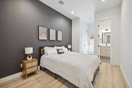 A spacious secondary bedrooms offers engineered wood flooring, recessed lighting, and direct access to your private yard. A sizable jack & jill bathroom is shared among the bedrooms.
