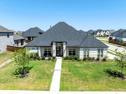 Front elevation with trees and landscaped beds