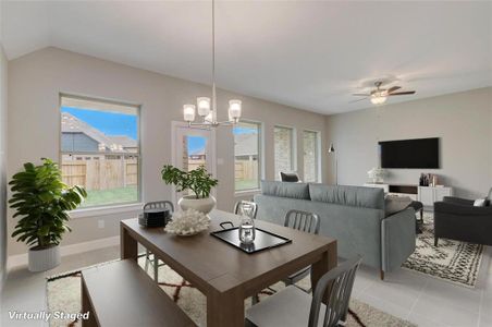 Spacious open floor plan seamlessly blends family room and dining area, perfect for modern living.