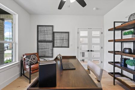 Office with light hardwood / wood-style flooring and ceiling fan