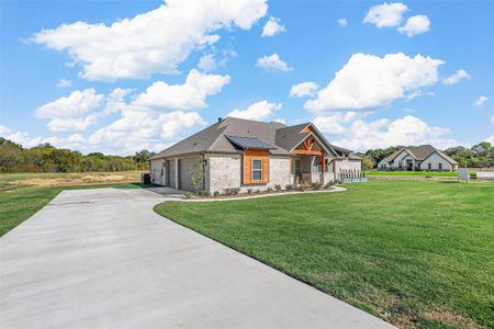 View of front of property with a front lawn and a garage