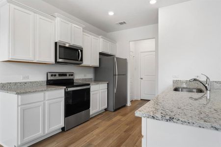 In the kitchen you will find granite countertops, luxury vinyl plank flooring, stainless steel energy-efficient Whirlpool appliances - including refrigerator with ice-maker.