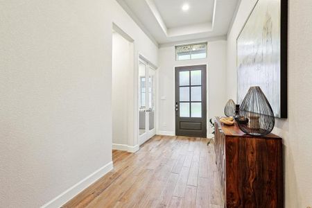 Entryway framed by office with French Doors.