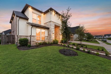 Situated on a corner lot, the home features a contemporary design with clean lines and large windows that invite natural light.