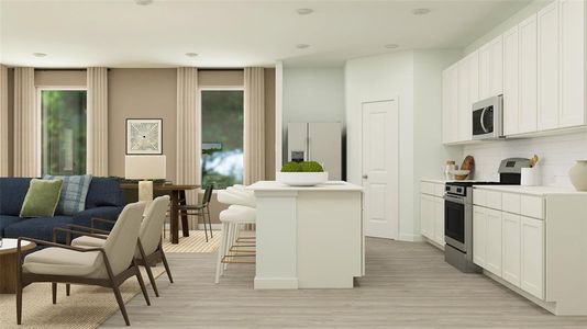 Kitchen with white cabinetry, appliances with stainless steel finishes, a breakfast bar area, and an island with sink