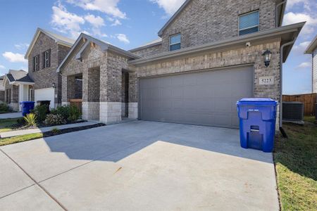 View of front facade with a garage and central AC unit