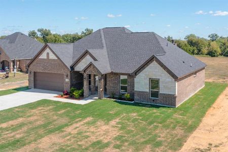 View of front of property featuring a front lawn and a garage