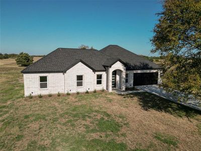 View of front of home with a front lawn and a garage