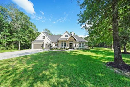 Be greeted with outstanding curb appeal with over 2.3 acres of wooded land with a sprinkler system for easy care.