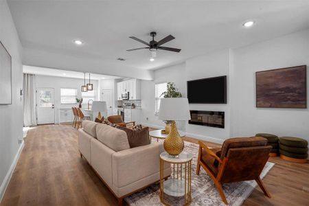 Living room featuring hardwood / wood-style floors, ceiling fan, and plenty of natural light