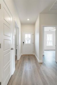 Entryway featuring light hardwood / wood-style flooring, ceiling fan, and a healthy amount of sunlight