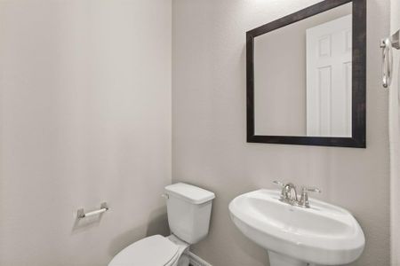 This charming home features a beautifully appointed half bath adjacent to the family room, perfect for welcoming guests and adding convenience to your daily life.