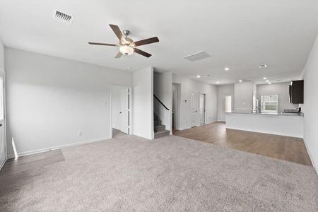Living room with ceiling fan and carpet flooring