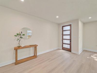 Entrance foyer with light wood-type flooring