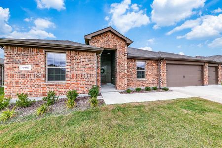 View of front of house with a front yard and a garage