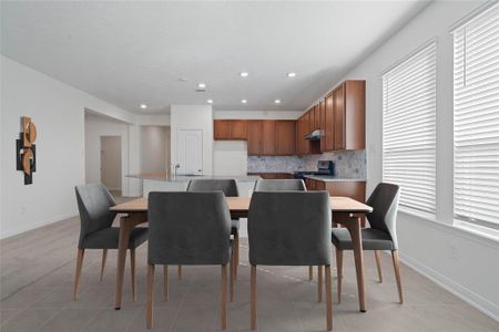 Make memories gathered around the table with your family and friends! This dining space features, recessed lighting, high ceilings, large windows with privacy blinds, and easy access to your kitchen and living room.