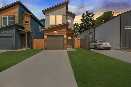 Modern home featuring a garage and a yard