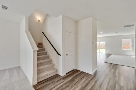 Staircase featuring hardwood / wood-style floors