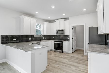 Lots of counter space in this spacious kitchen, including a large walk-in pantry