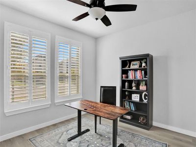 Light and airy office space with plantation shutters.