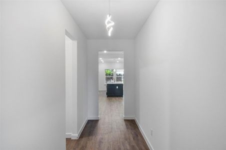 Hallway featuring dark wood-type flooring